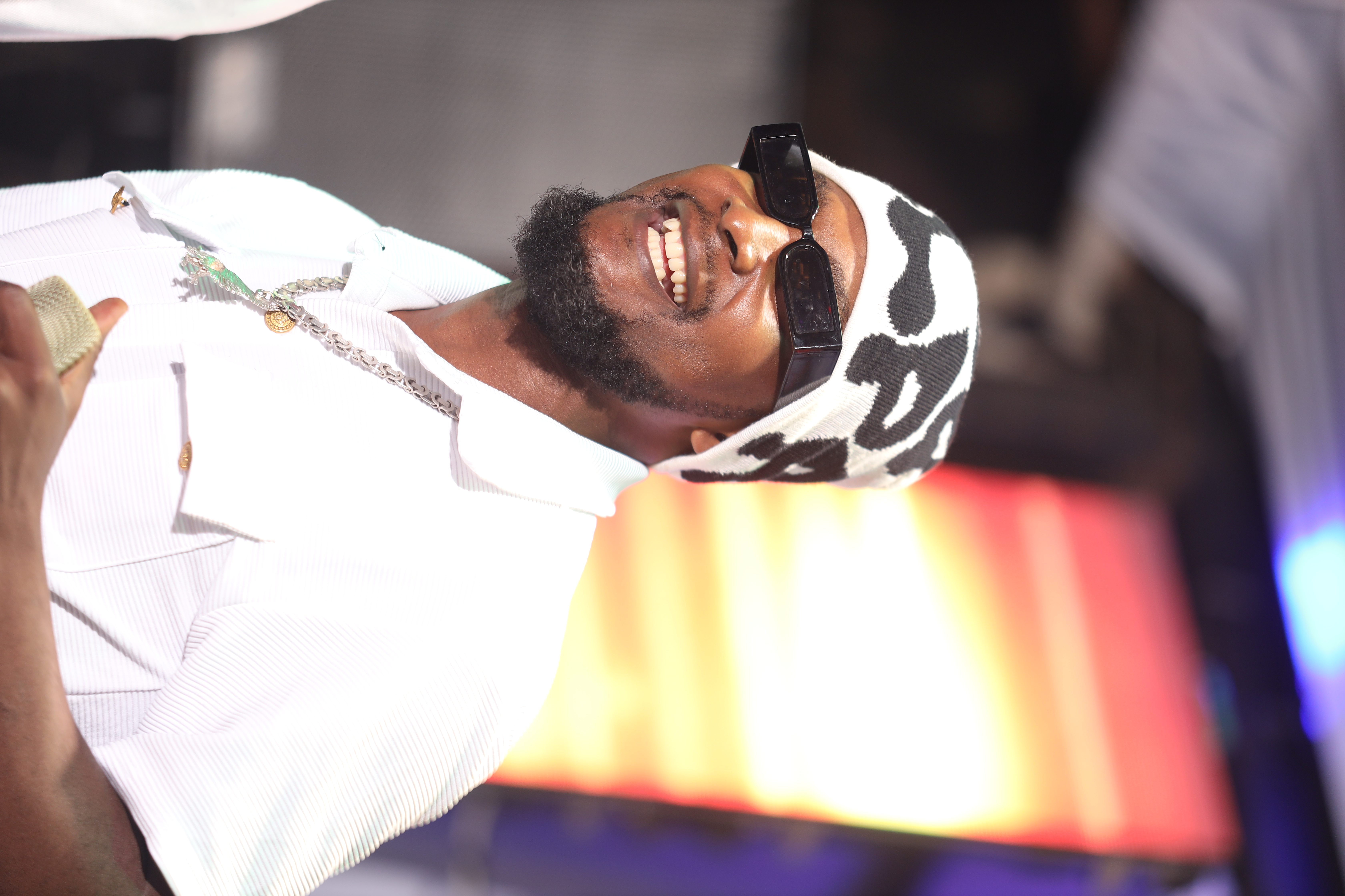 Moyo House artist performing under warm stage lights